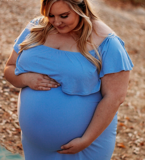 pregnant mama wearing blue dress looking at belly
Sacramento and Placer County photographer